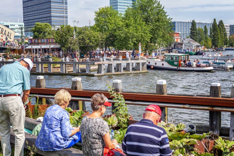Amsterdam, Netherlands, 08/22/2015: Sail Amsterdam festival. Boats and ships on the canals of the city. Visitors to the show walk. On the promenade. Horizontal royalty free stock images Amsterdam, Netherlands, 08/22/2015: Sail Amsterdam festival. Boats and ships on the canals of the city. Visitors to the show walk. On the promenade. Horizontal royalty free stock images