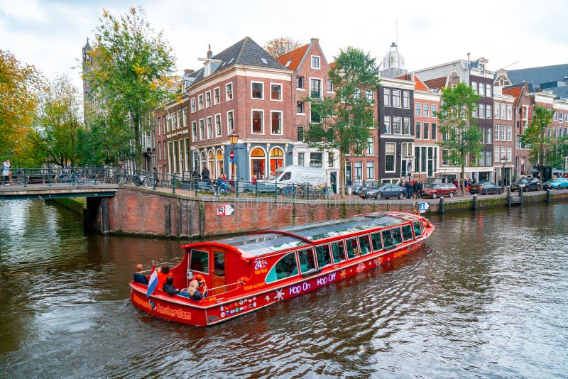 Amsterdam, Netherlands - 15.10.2019: Typical Amsterdam scene with colored buildings, canals, bridges and bicycles