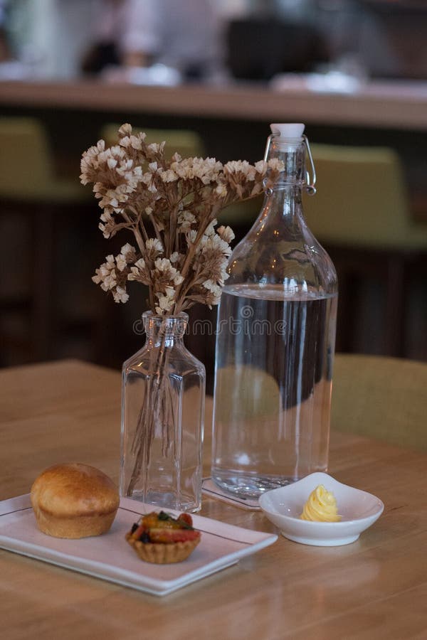 Amuse Bouche of Fruit Tart and Bread and Butter and Bottle of Water