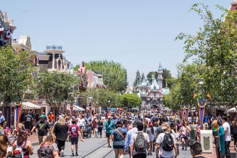 Funny Streets Of Disneyland Park. A Crowd Of Walking Merry People ... Weird People At Disneyland