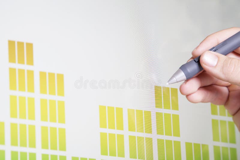 A man holds a stylis and analyzes charted data on a screen. A man holds a stylis and analyzes charted data on a screen.