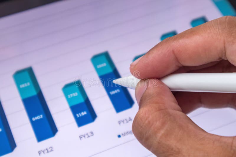 Analyst pointing to a growth chart of business financial data on digital screen royalty free stock images