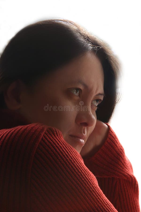 Asian beauty with red wool knitted sweater in earnest. Fit for analysis, serious business, viewer, homesickness, good listener, gloom, etc. concept. Asian beauty with red wool knitted sweater in earnest. Fit for analysis, serious business, viewer, homesickness, good listener, gloom, etc. concept.