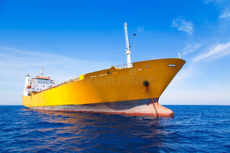 Anchor cargo yellow boat in blue sea stock images