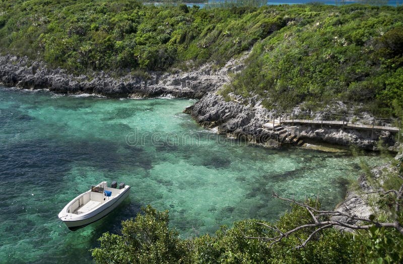 Anchored boat next to tropical island