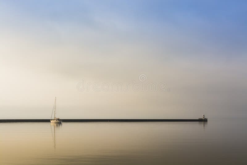 Anchored sailingboat early morning