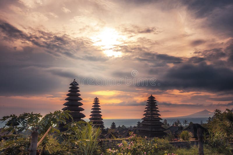 Bali Pura Besakih temple towers from high viewpoint on horizon and volcano during sunset as Bali travel lifestyle royalty free stock photography