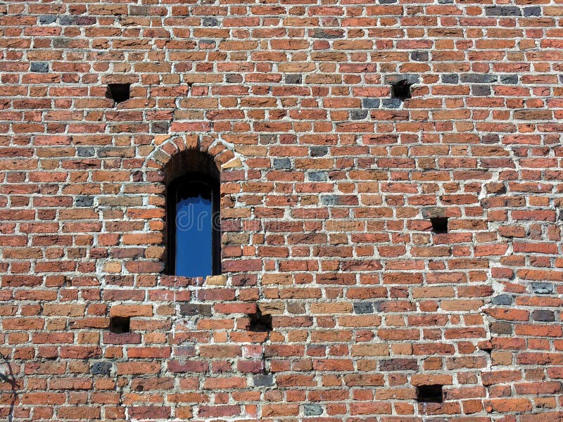 Ancient brick wall with window