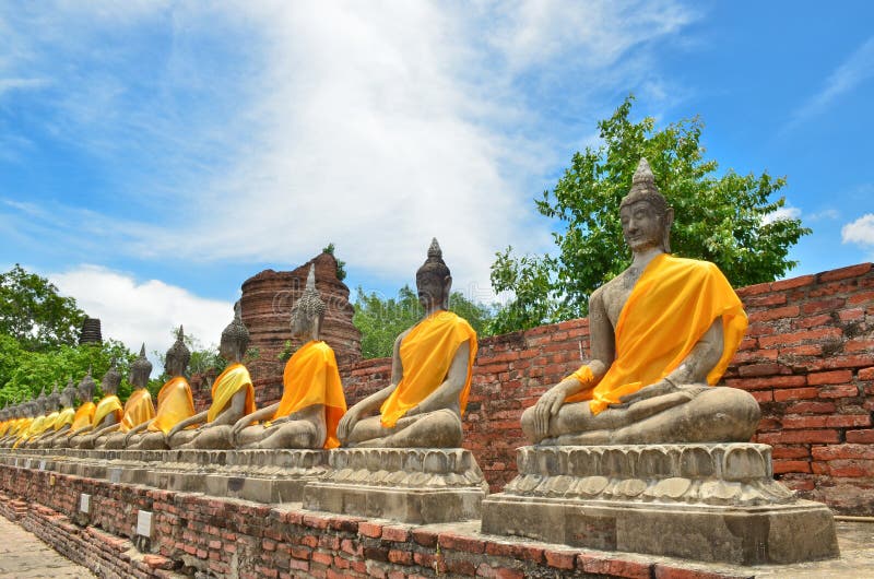 Ancient buddha statues with blue sky in Thailand