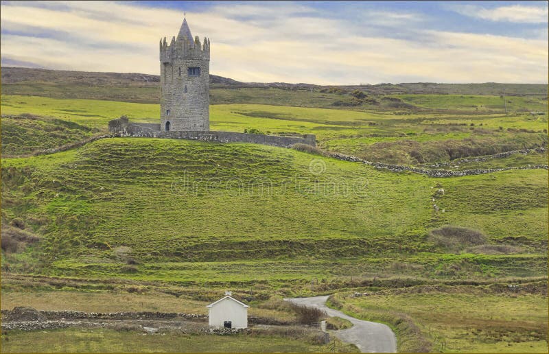 Ancient castle stood on a hill overlooking a small white cottage stock image