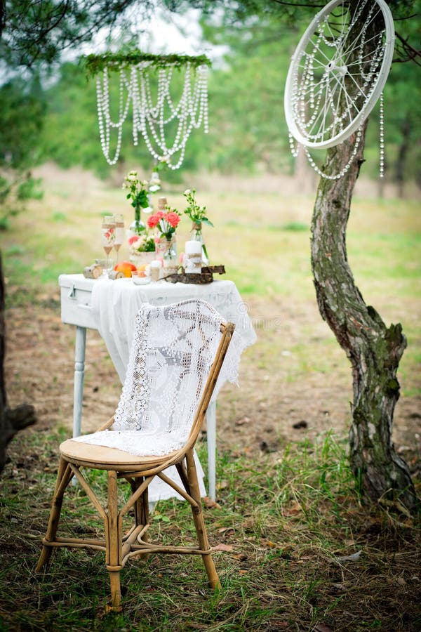 Ancient chair against wedding decoration in style of a shabby shabby chic. Decoration of a wedding photoshoot.