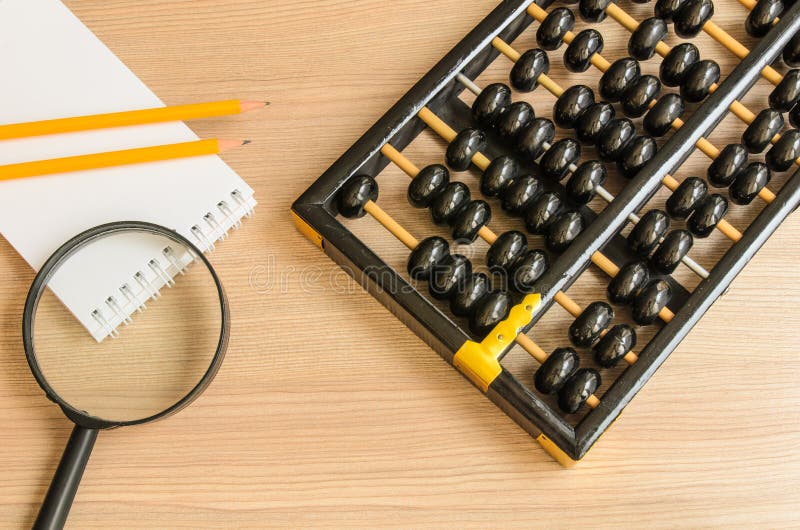 Ancient Chinese abacus,notebook,pencil,glass