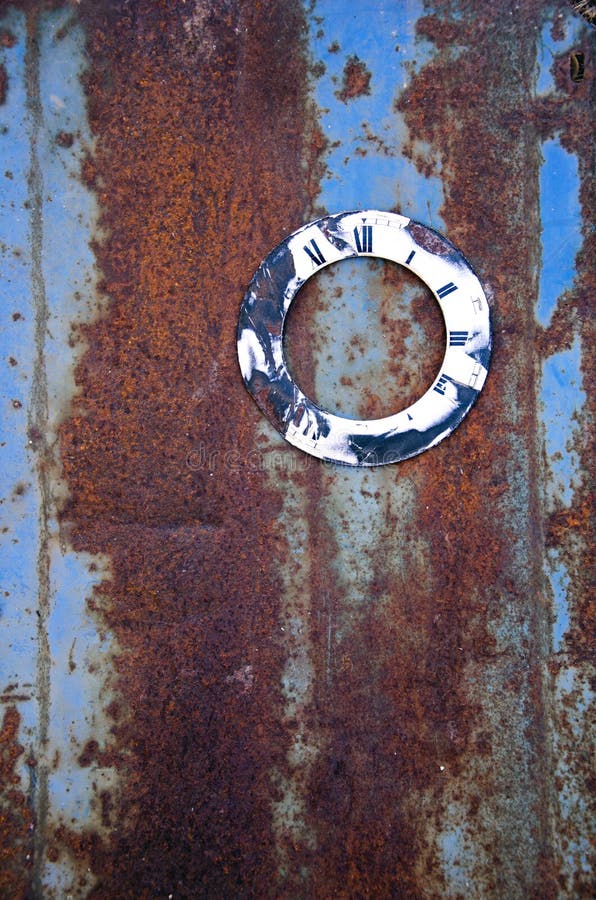 Ancient clock face on rusty metal tin royalty free stock photos
