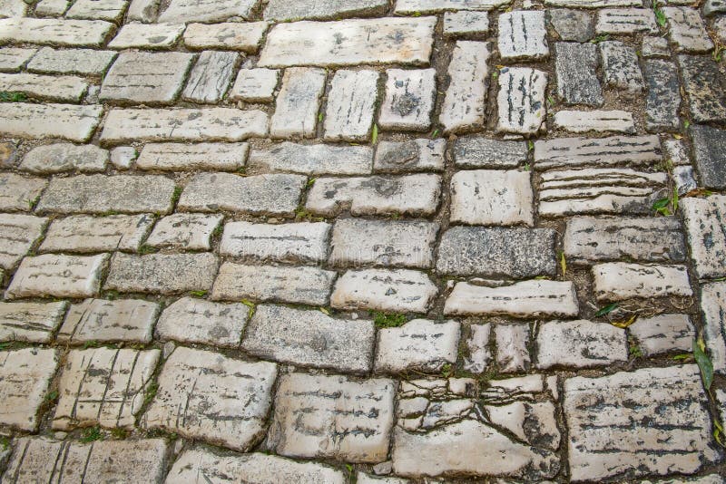 The ancient cobblestone pavement close-up. Background of natural stone. Ancient cobblestone pavement close-up. Background of natural stone royalty free stock photos The ancient cobblestone pavement close-up. Background of natural stone. Ancient cobblestone pavement close-up. Background of natural stone royalty free stock photos