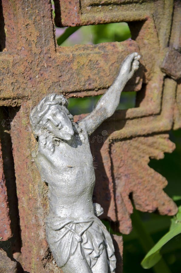 Ancient crucifixion with one hand Jesus christ on rusty cross royalty free stock images