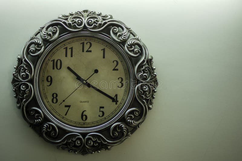 Ancient Designer Wall Clock with Light Yellow Back Ground Showing Time