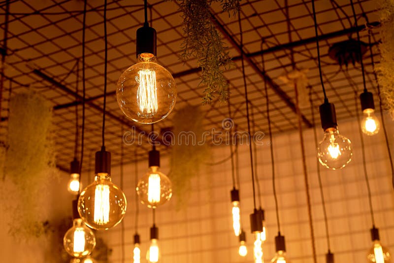 Ancient Edison Lamps on Black Wires.Warm Light in the Design of the