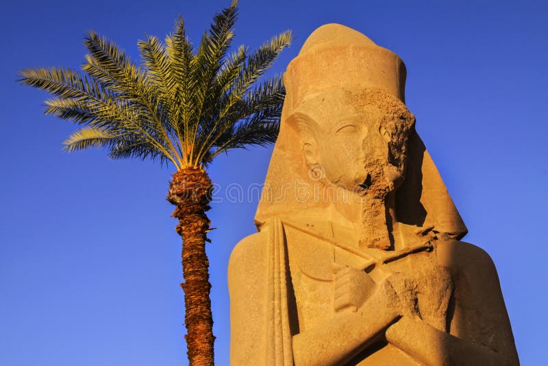 Ancient Egyptain Statue and Palm Tree Karnak Temple Luxor Egypt Stock