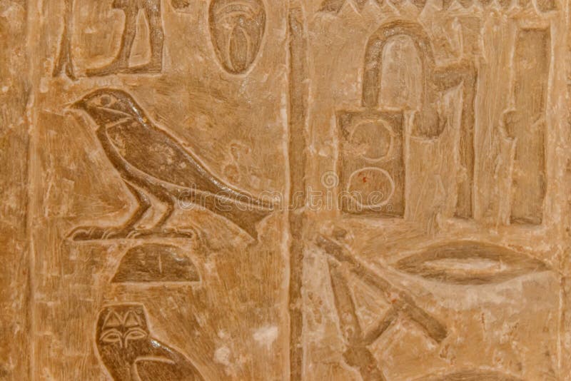 Ancient Egyptian Paintings and Hieroglyphs Carved on a Stone Wall Stock