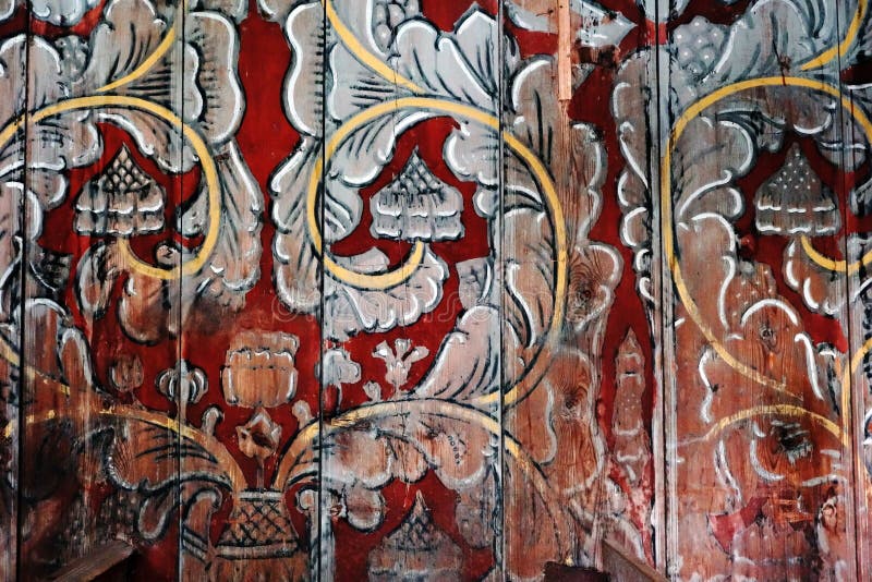 Floral nordic ornament on a wooden wall of a Stave church in Norway