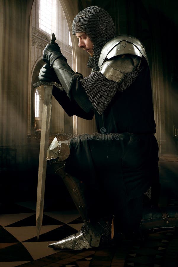 Ancient knight in metal armor stock photo