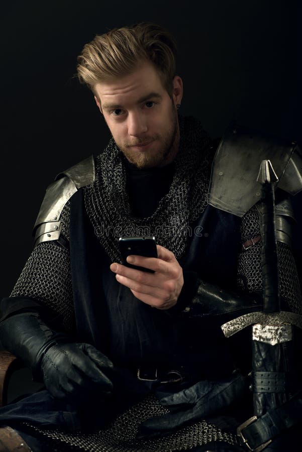 Ancient knight and mobile phone stock images