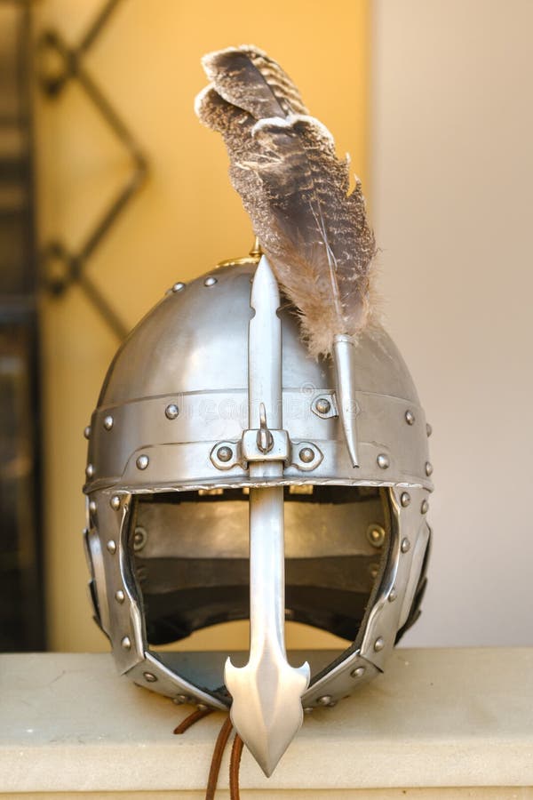 An ancient knight's helmet with a feather. Medieval concept royalty free stock photos