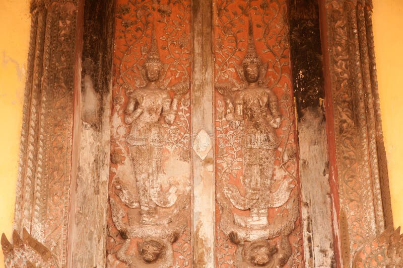 Ancient Laos art wood carving on church in Si Saket temple in Laos.