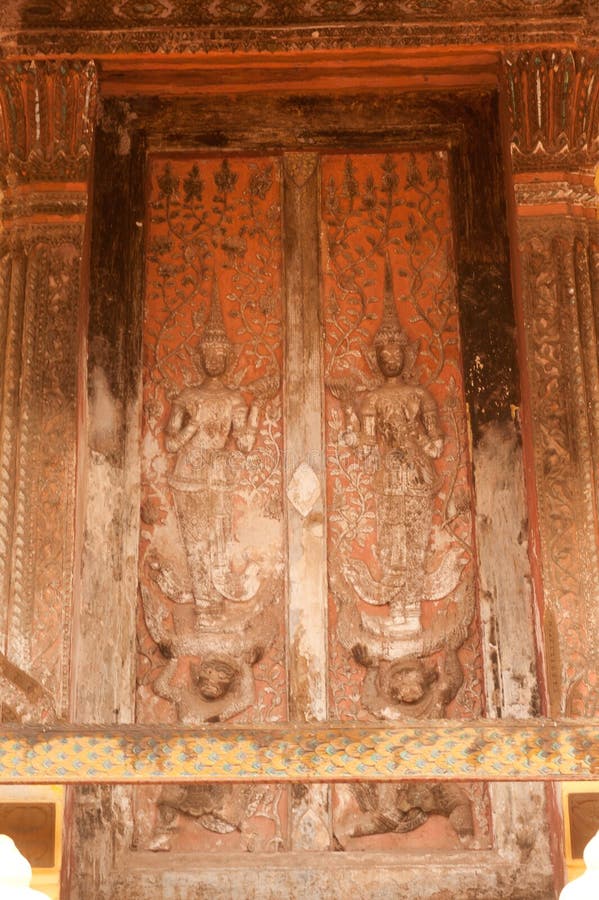 Ancient Laos art wood carving on church in Si Saket temple in Laos.