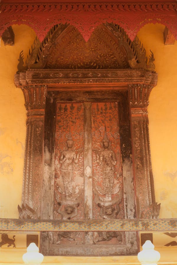 Ancient Laos art wood carving on church in Si Saket temple in Laos.