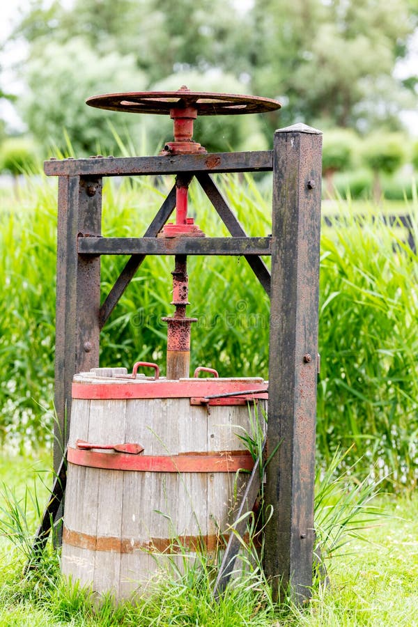 Ancient machine of the Dutch to press cheese stock images