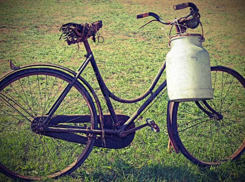 Ancient milking bike with milk bin stock photography Ancient milking bike with milk bin stock photography