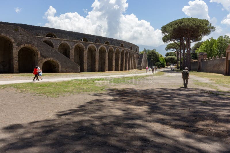 Ancient roman amphitheatre exterior in Pompeii, Italy. Traditional antique colliseum and trees with shadows in Pompeii. royalty free stock photography Ancient roman amphitheatre exterior in Pompeii, Italy. Traditional antique colliseum and trees with shadows in Pompeii. royalty free stock photography