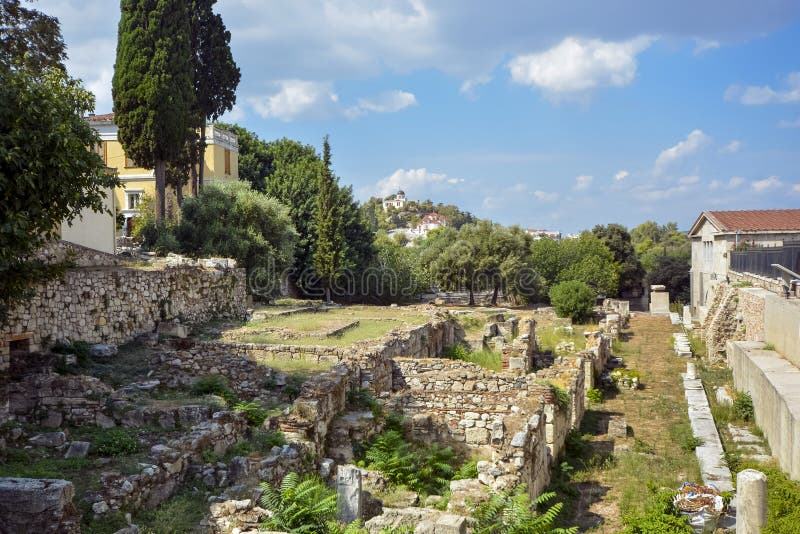 The ancient ruins of the Roman Agora in Athens with a church and temple atop a hill in the distance on a warm summer day royalty free stock photos The ancient ruins of the Roman Agora in Athens with a church and temple atop a hill in the distance on a warm summer day royalty free stock photos