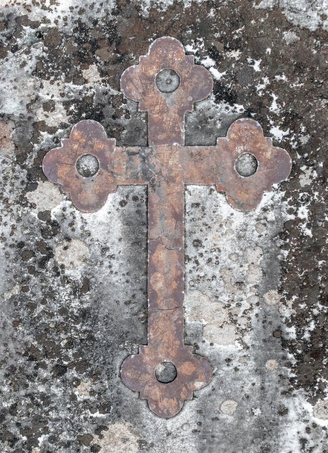 Ancient rusty cross on a old stone stock photos