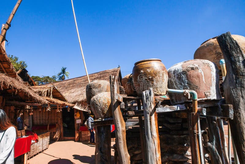 Ancient salt pits showing platform, earthenware water jars, souvenirâ€™ salt stand behind. Ancient method of boiling brine into stock photography