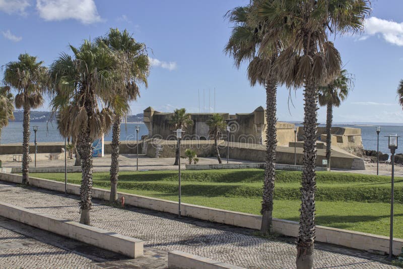 Ancient sea fortress in Caxias, Portugal, surrounded by a palm tree garden