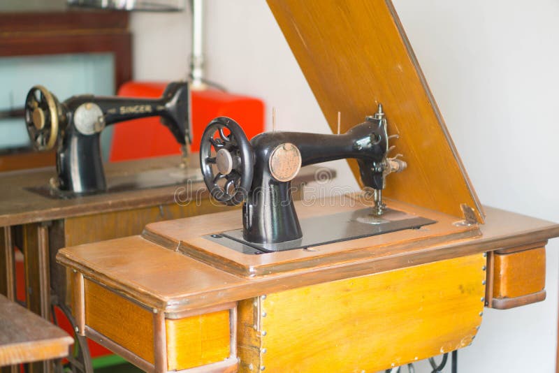 Ancient sewing machine on the table stock photo