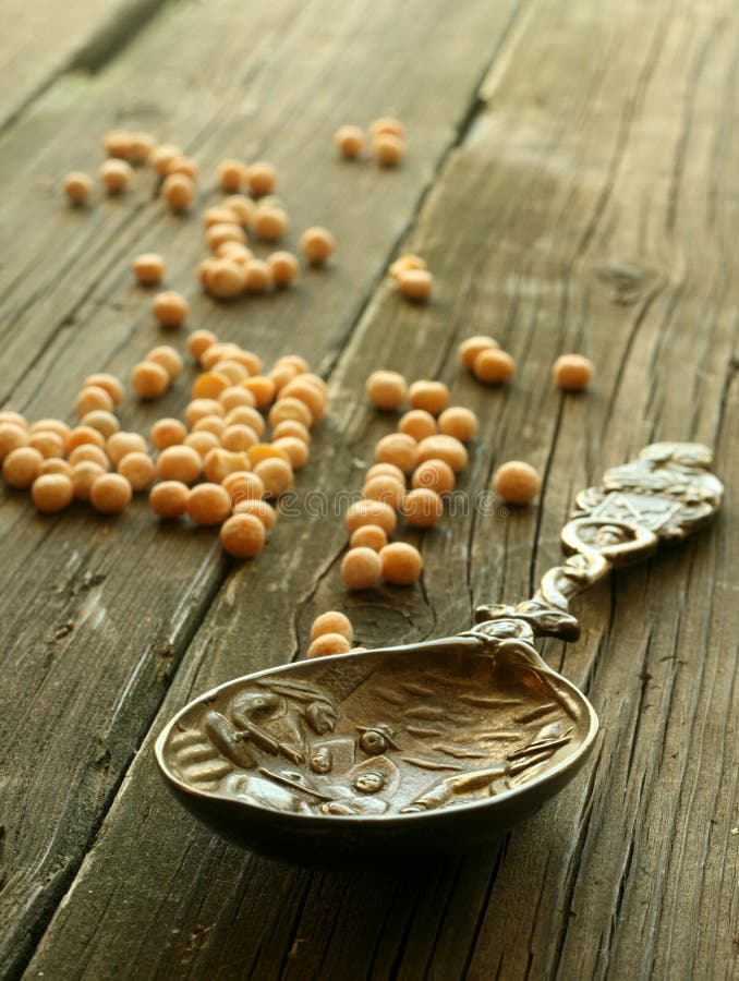 Ancient spoon with stamping on old wooden