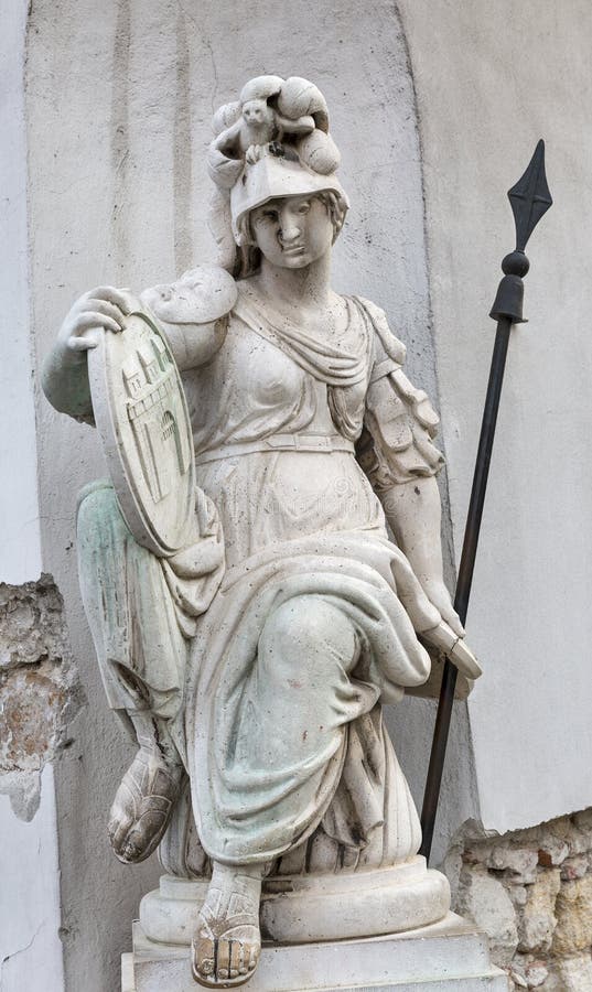 Ancient woman warrior statue on Holy Trinity Column on Trinity Square in front of Matyas Church, Buda Castle area, Budapest, Hungary. Ancient woman warrior statue on Holy Trinity Column on Trinity Square in front of Matyas Church, Buda Castle area, Budapest, Hungary