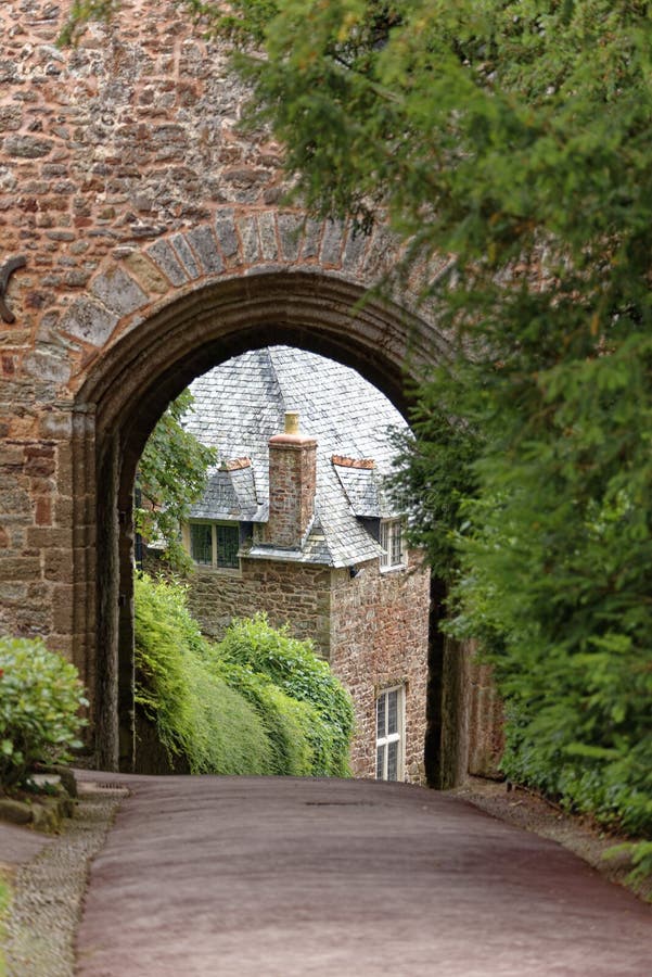 An ancient stone archway and house in Dunster castle, somerset, UK, Europe. An ancient stone archway and house in Dunster castle, somerset, UK, Europe.