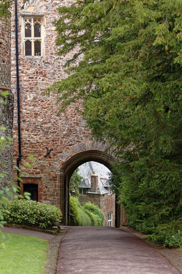 An ancient stone archway and house in Dunster castle, somerset, UK, Europe. An ancient stone archway and house in Dunster castle, somerset, UK, Europe.