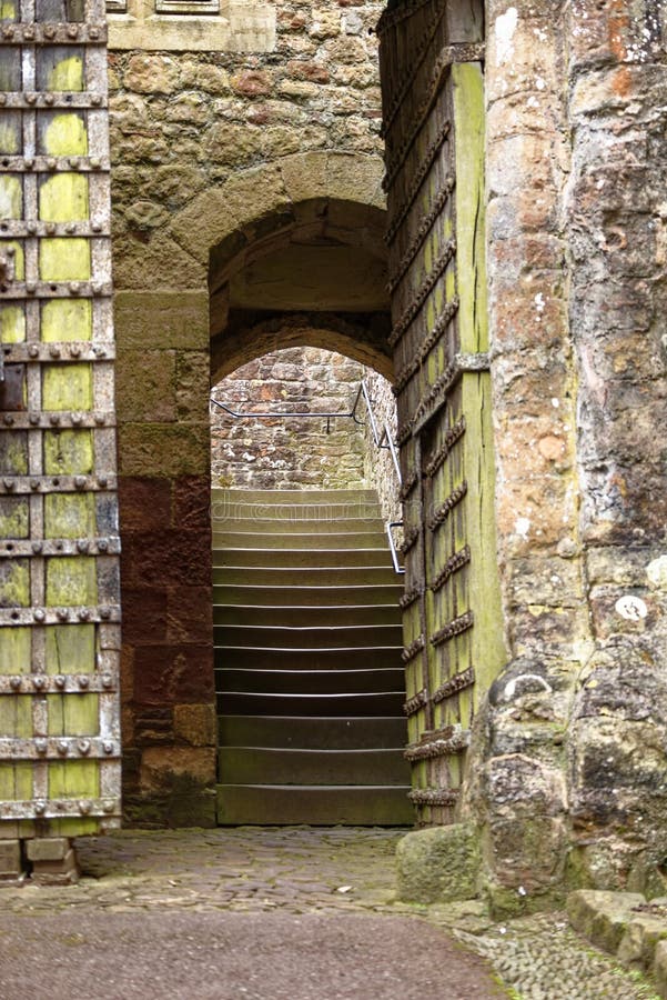 An ancient stone archway and house in Dunster castle, somerset, UK, Europe. An ancient stone archway and house in Dunster castle, somerset, UK, Europe.