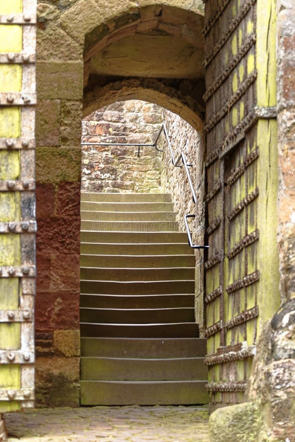 An ancient stone archway and house in Dunster castle, somerset, UK, Europe. An ancient stone archway and house in Dunster castle, somerset, UK, Europe.