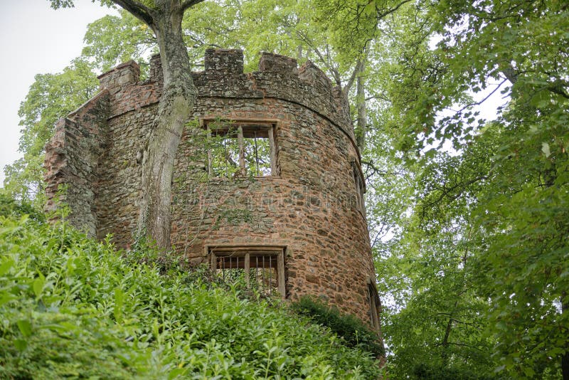 Ancient stone turret surrounded by trees with windows, dunster castle, somerset, England, Europe. Ancient stone turret surrounded by trees with windows, dunster castle, somerset, England, Europe