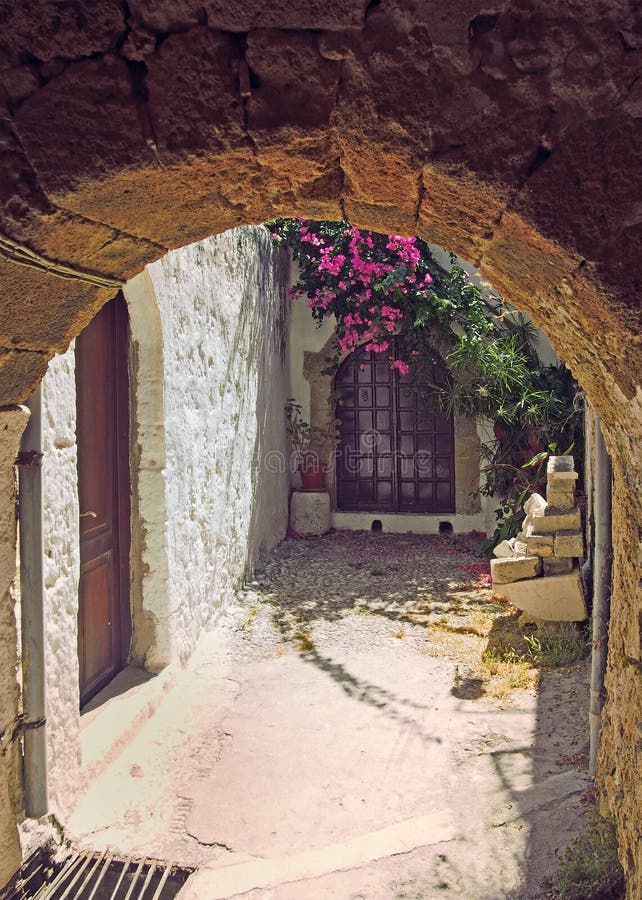 An Ancient Sunlit Alleyway in Rhodes Town Under a Stone Arch with ...