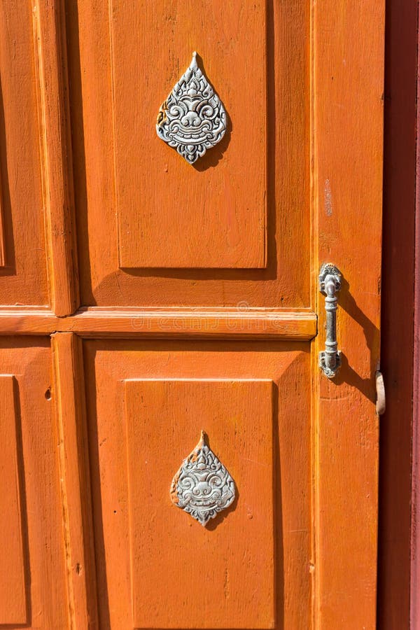 Ancient traditional thailand silverware art on the wooden door royalty free stock photography Ancient traditional thailand silverware art on the wooden door royalty free stock photography