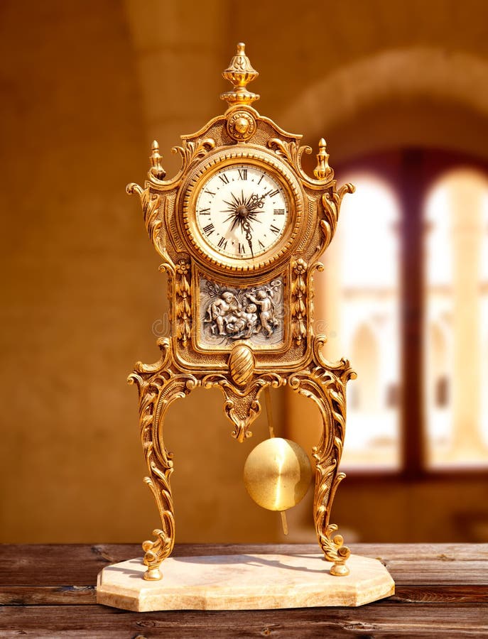 Ancient vintage golden brass pendulum clock royalty free stock photography Ancient vintage golden brass pendulum clock royalty free stock photography