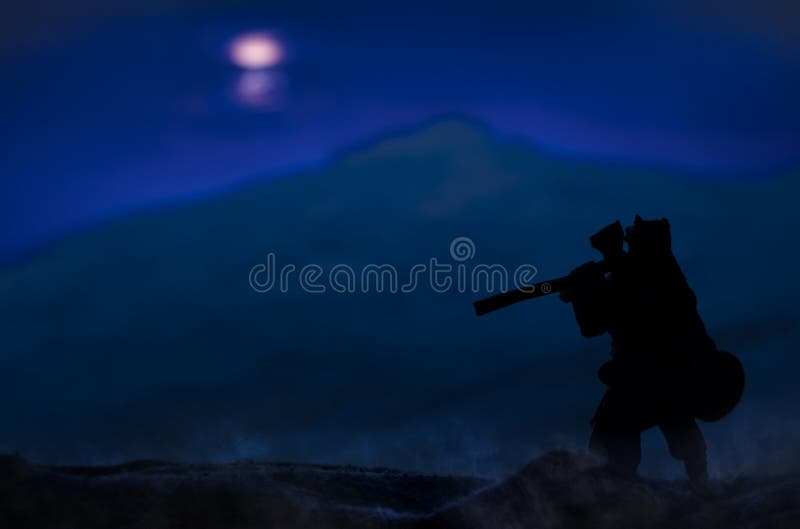 Ancient warrior stranger vagabond person silhouette in fur cape with ax stay back to camera on a hill at phantom blue night nature