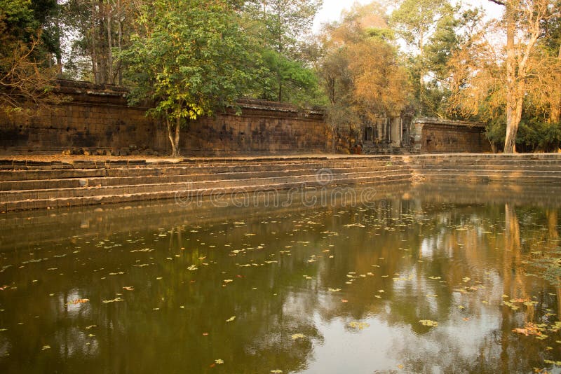 Ancient Water Pool by a Broken Temple Wall in Angkor